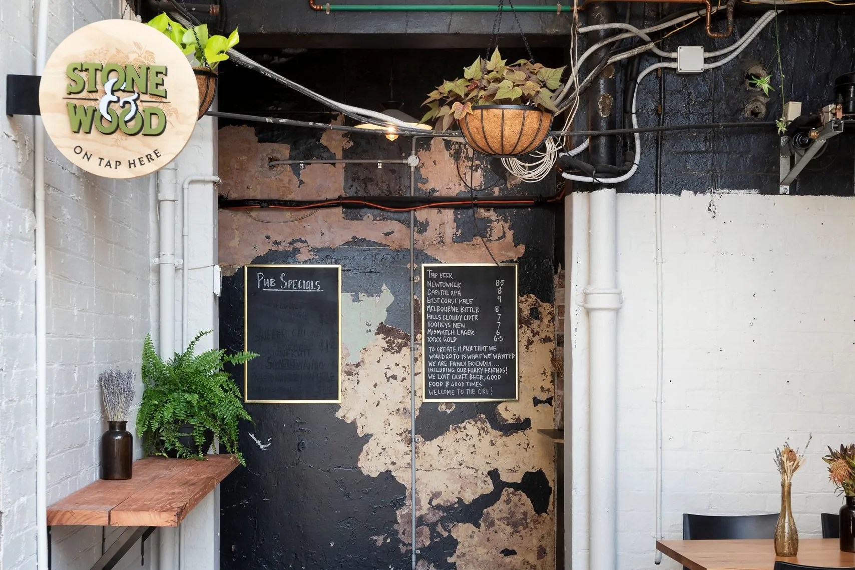A restaurant entrance featuring wooden furniture.