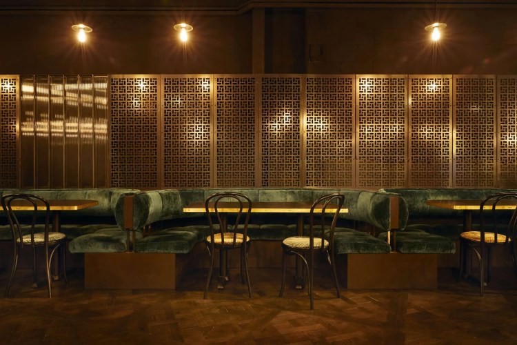 A restaurant with green booths and wooden walls. A restaurant with green booths and wooden walls.
