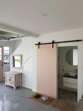 A room with a barn door and white walls. A room with a barn door and white walls.