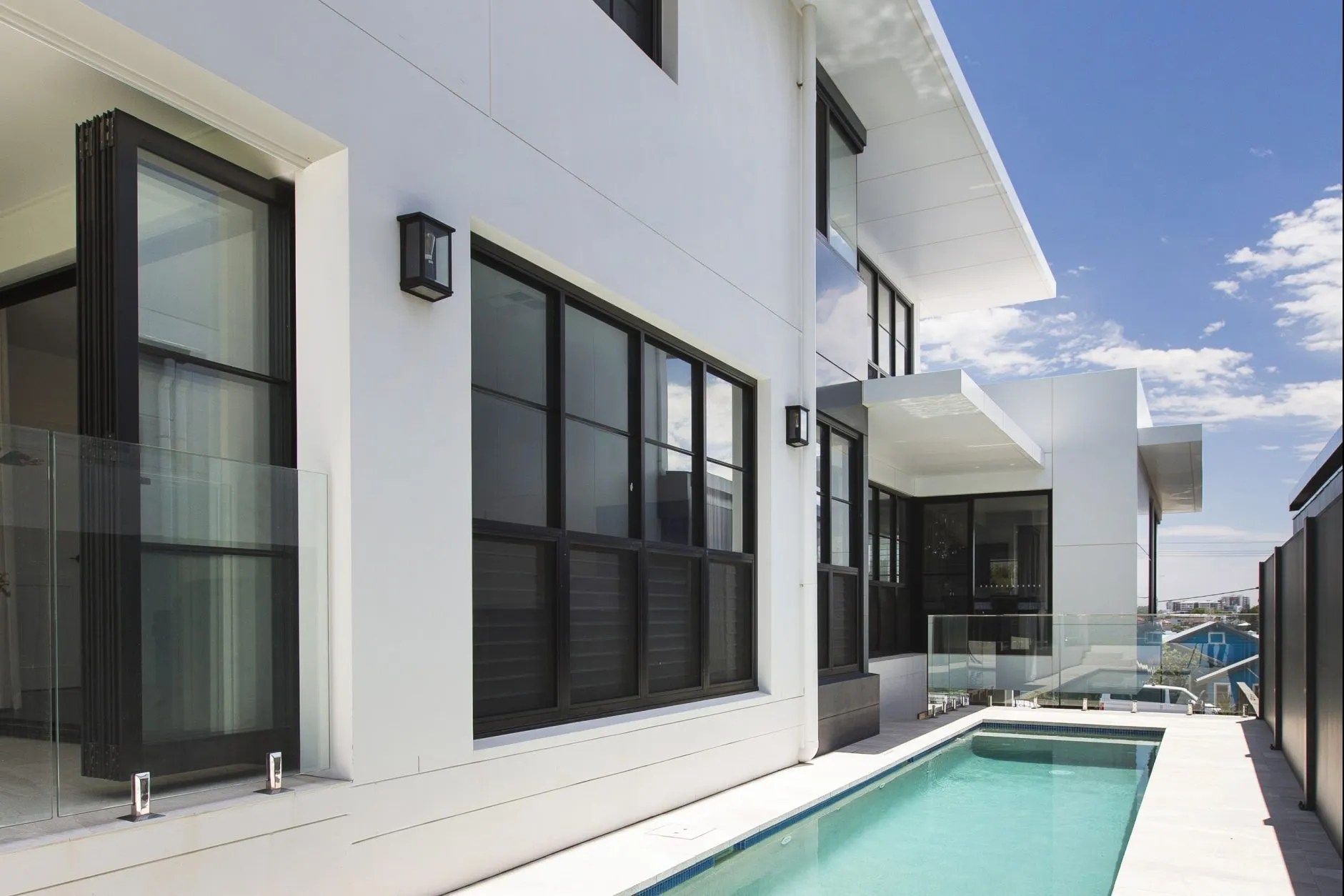 A residential house with a pool in the backyard.
