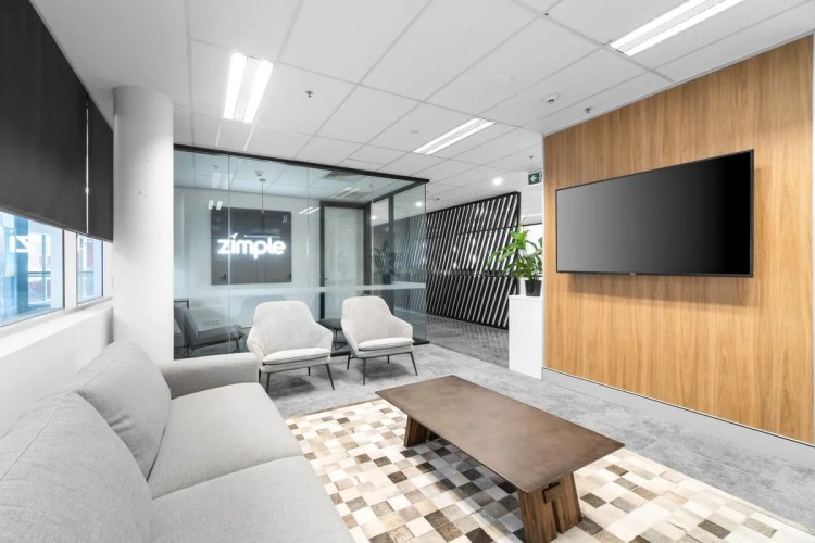 A modern office with a tv and couches. A modern office with a tv and couches.